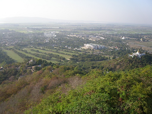 P1090178.JPG - Once on the terrace of the Sutaungpyei Pagoda, a panoramic view of the Mandalay plain stretches far to the horizon, with the old city walls and moat, the Thudhamma Zayats (rest houses), various stupas around such as the Kuthodaw Pagoda and its 729 satellite stupas each housing a page inscribed in stone the world's largest book (the entire Pali Buddhist Canon), Kyautawgyi and Sandamuni Pagodas, the Irrawaddy to the west and the Minwun Hills on its opposite bank, the road to Madaya and Mogok to the north, and the Shan Yoma range of mountains to the east.